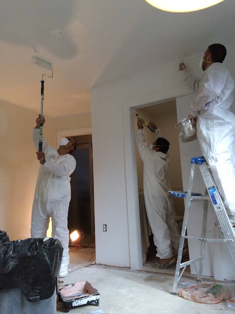 The 1776 Painting Co crew prepping and painting an interior room